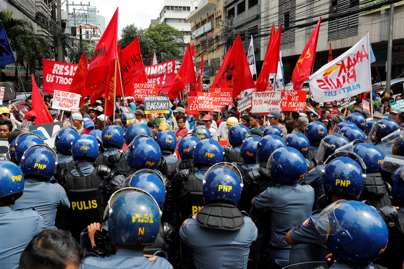 Tactical police officers block protesters trying to march towards the U.S. embassy during a rally against U.S. President Donald Trump's visit, in Manila, Philippines November 10, 2017.