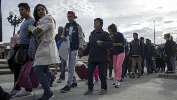 Migrants and supporters arrive at border to protest crimallization.