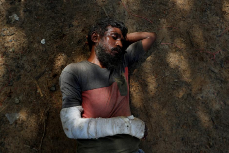 Imam Hossain, 42, sleeps on the ground at Kutupalang refugee camp in Bangladesh. His right arm swathed in bandages from the knuckles of his hand to well above the elbow, Hossain lay exhausted on the roadside near the Kutupalong camp. He was returning home after teaching at a madrassa in his village when three men attacked him with knives. The next day, he made his wife and two children leave with other villagers fleeing to Bangladesh. He reached Cox’s Bazar later. He was still searching for his family. “I want to ask the Myanmar government why they are harming the Rohingya,” he said. “Why do Buddhists hate us? Why do you torture us? What is wrong with us?”
