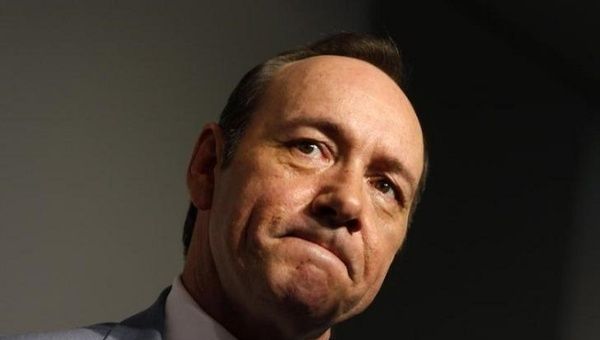 Actor Kevin Spacey speaks to a reporter as he arrives during the premiere of 