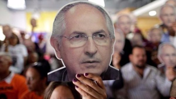 People hold portraits of opposition leader Antonio Ledezma during a news conference at the Venezuelan coalition of opposition parties (MUD) headquarters in Caracas, Venezuela August 1, 2017.
