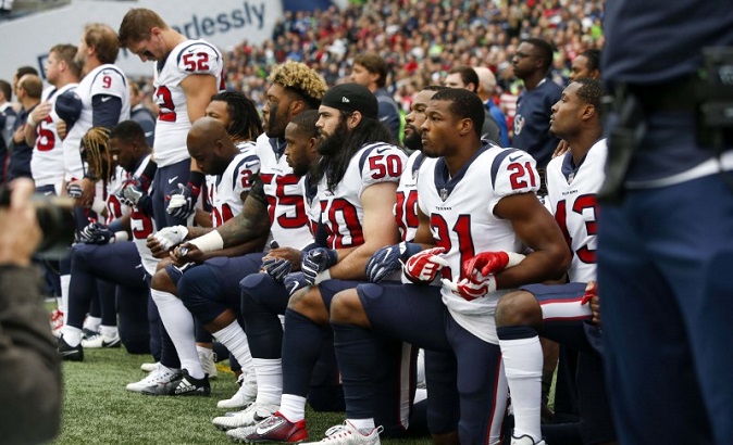 Houston Texans’ Benardrick McKinney, Ben Heeney, Marcus Gilchrist and teammates kneel during the national anthem before kickoff against the Seattle Seahawks.
