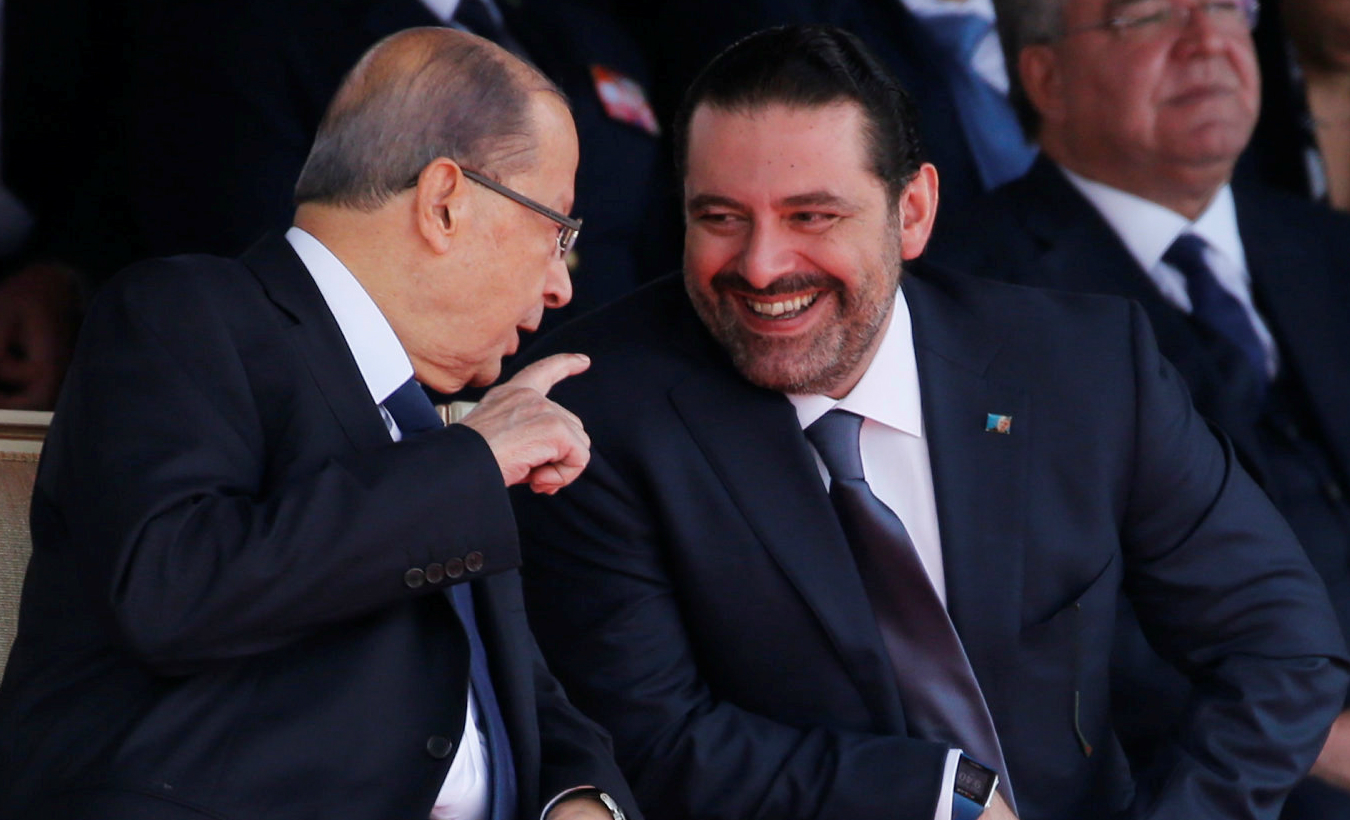 Saad al-Hariri who suspended his decision to resign as prime minister reacts as he talks with Lebanese President Michel Aoun while attending a military parade to celebrate the 74th anniversary of Lebanon's independence in downtown Beirut, Lebanon, Nov. 22, 2017.