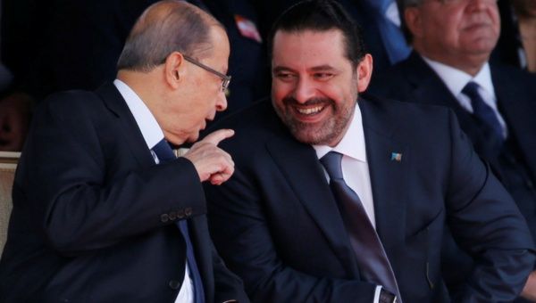 Saad al-Hariri who suspended his decision to resign as prime minister reacts as he talks with Lebanese President Michel Aoun while attending a military parade to celebrate the 74th anniversary of Lebanon's independence in downtown Beirut, Lebanon, Nov. 22, 2017. 