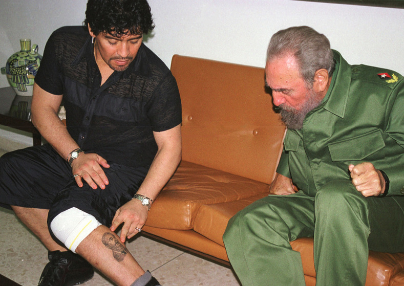 Perhaps the most famous Fidel tattoo is that of Argentine football star Diego Maradona, pictured here showing it off to El Commandante himself.