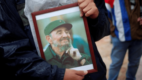 A supporter holds an image of former Cuban leader Fidel Castro at a tribute in Malaga, southern Spain, December 4, 2016.
