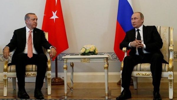 Russian President Vladimir Putin speaks to Turkish President Tayyip Erdogan during their meeting in St. Petersburg, Russia, August 9, 2016. 