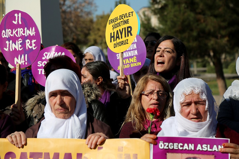A demonstrator shouts slogans as she holds a placard during a gathering in Diyarbakir, Turkey.
