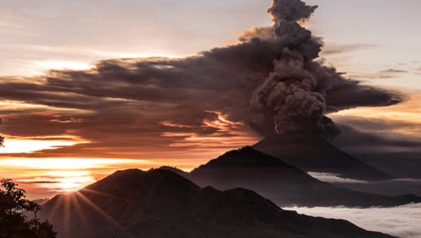 Mount Agung volcano is seen spewing smoke and ash in Bali on Sunday. 
