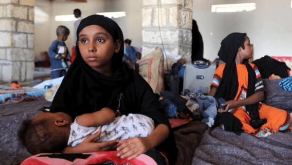 A Yemeni girl holds a baby in a temporary shelter after fleeing violence in Yemen, at the port town Bosasso in Somalia's Puntland. 