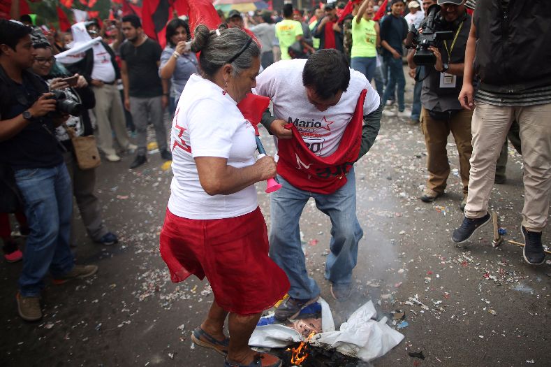 Supporters of Nasralla trample on a picture of incumbent candidate Juan Orlando Hernandez.