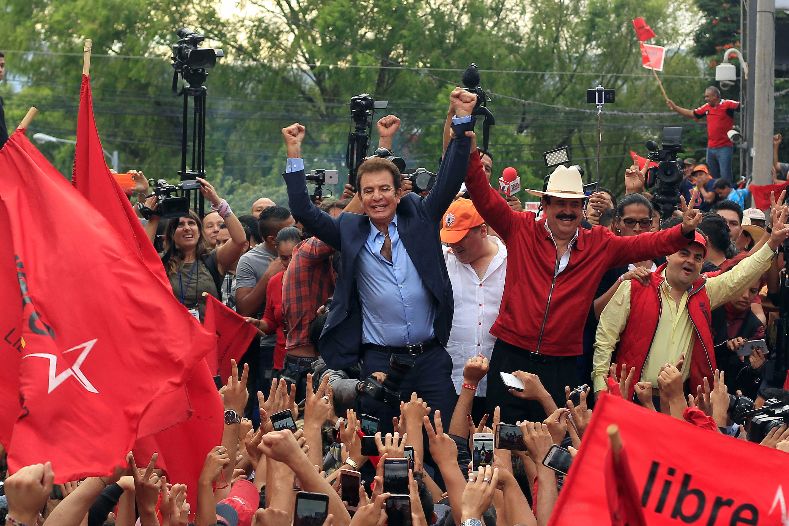 Nasralla celebrates with former president Manuel Zelaya, who backs the opposition alliance.