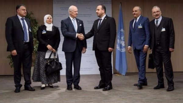 U.N. Special Envoy for Syria, Staffan de Mistura shakes hands with the head of the Syrian Negotiation Commission, Nasr al-Hariri.