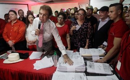 Salvador Nasralla, presidential candidate for the Opposition Alliance Against the Dictatorship, shows the tallies of ballot counting during a news conference in Tegucigalpa.