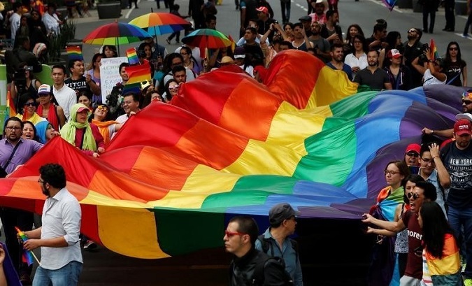 The LGBTI community wave a rainbow flag during a march in support of gay marriage, sexual and gender diversity in Mexico City.