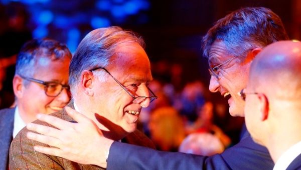 Jorg Meuthen (R) congratulates Alexander Gauland during the Alternative for Germany (AfD) congress in Hanover.