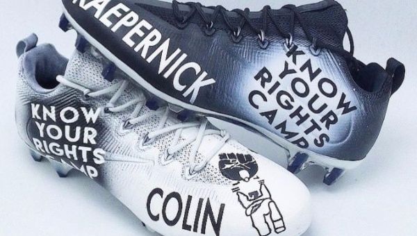 Cleats with Kaepernick's Know Your Rights Camp campaign logo.