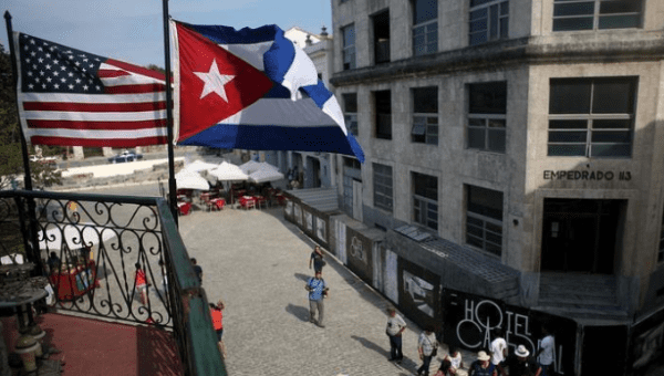 U.S. and Cuban flags hang on the terrace of a restaurant in downtown Havana, March 17, 2016.