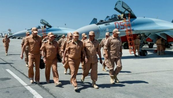 A handout picture taken on June 18, 2016 and provided by the Russian Defense Ministry shows Defense Minister Sergei Shoigu (C) visiting Russia's air base in Hmeimim in the Syrian coastal province of Latakia.