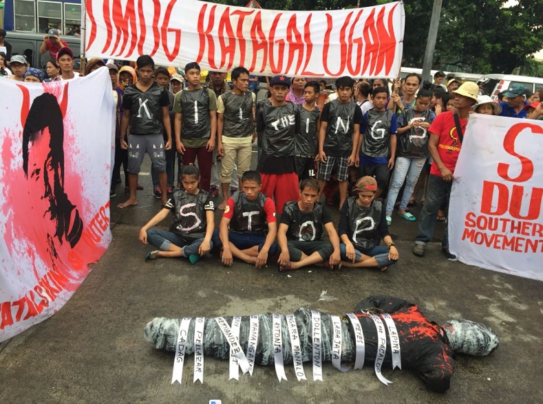 Activists mark the massacre of 15 members of the New People's Army, who were thought to have faced a hail of bullets without being given the chance to surrender.