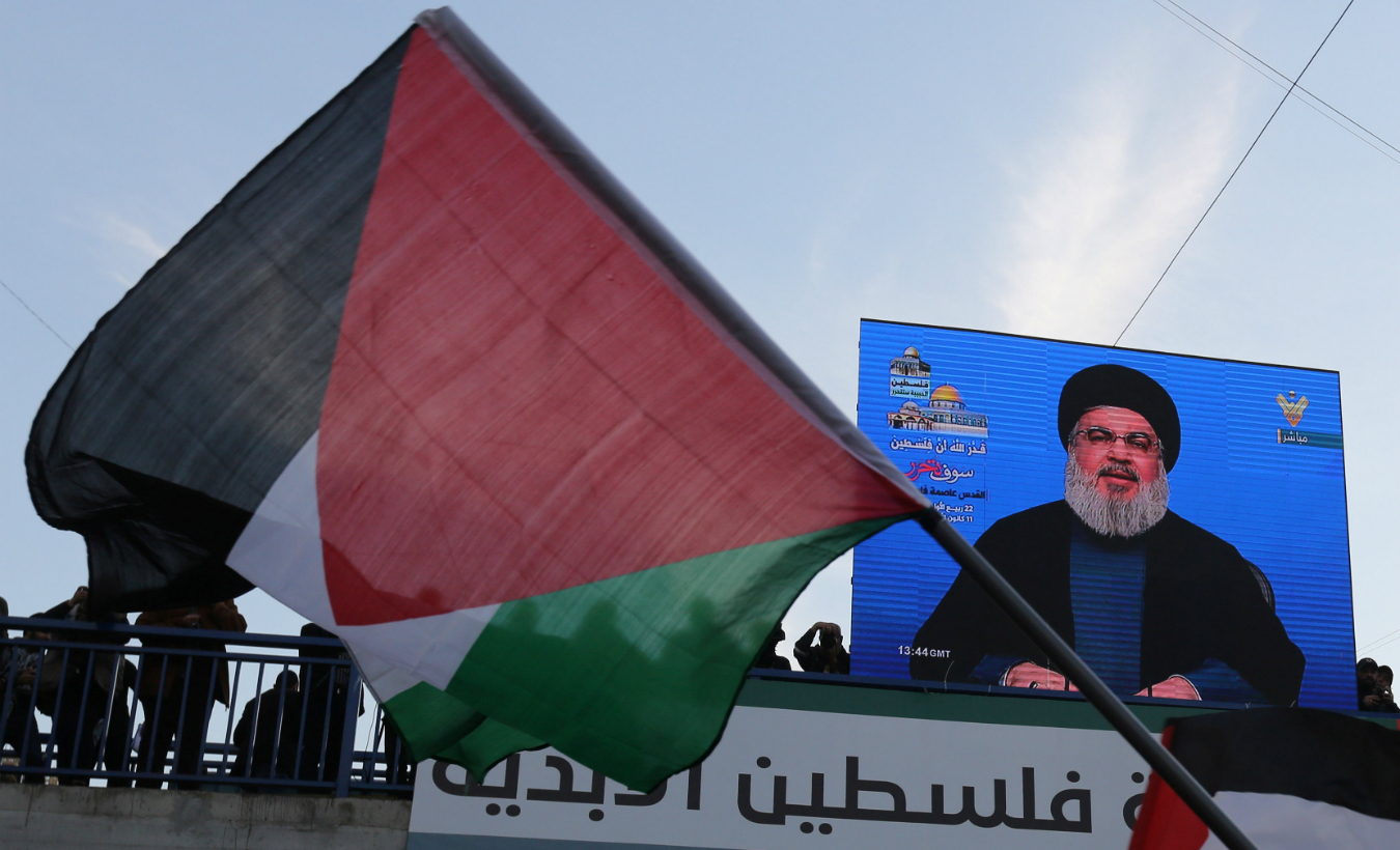 Lebanon's Hezbollah leader Sayyed Hassan Nasrallah speaks via a screen during a protest in Beirut's southern suburbs, Lebanon Dec. 11, 2017.