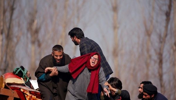  A woman cries next to the body of Yawar Bashir, a suspected militant, who according to the local media was killed in a gunbattle with Indian security forces on Monday, during his funeral procession at Hablish village in south Kashmir's Kulgam district December 5, 2017
