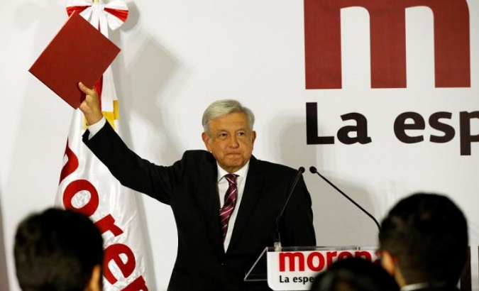 Mexican presidential candidate Andres Manuel Lopez Obrador shows a document during his registration as a pre-candidate for the July 2018 presidential election, in Mexico City, Mexico, Dec. 12, 2017.