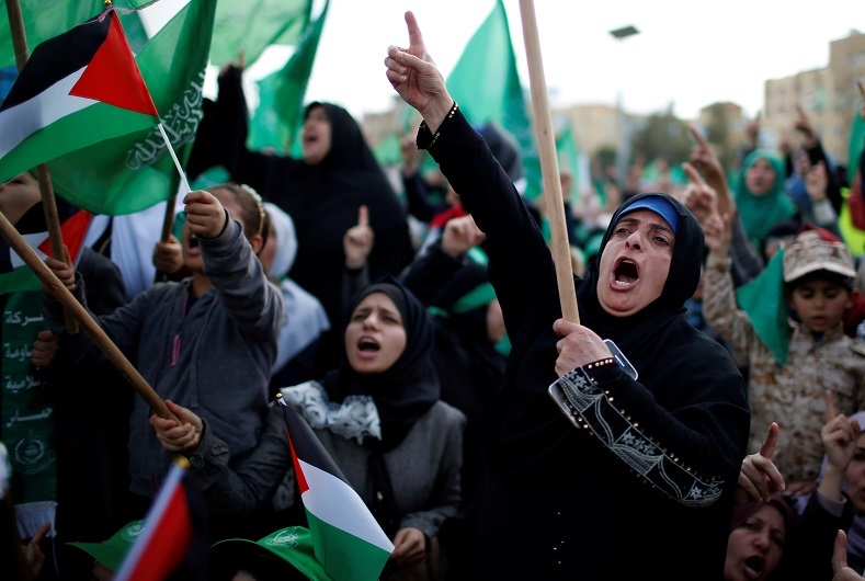 Palestinian women chant slogans during the rally.