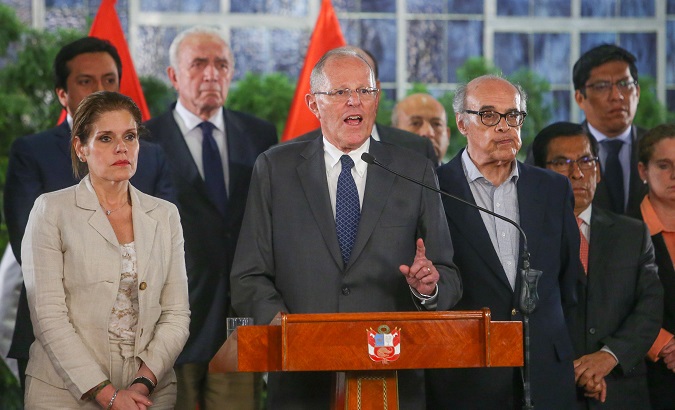 Peruvian President Pedro Kuczynski, flanked by vice-president Mercedes Araoz and his cabinet, gives a speech at the Government Palace.