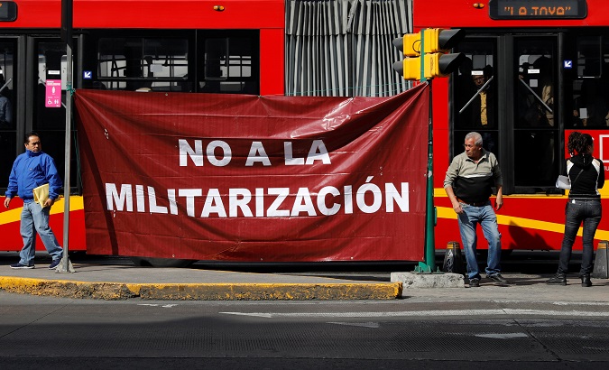 Activists hold a protest against a law that militarizes crime fighting in the country outside the Senate in Mexico City, Mexico December 14, 2017.