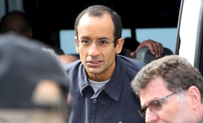 Marcelo Odebrecht, former CEO of Latin America's largest engineering and construction company, Odebrecht, is escorted by Federal Police officers.