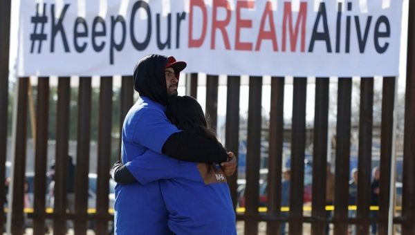 'Dreamers' hug as they meet with relatives during the 'Keep Our Dream Alive' binational meeting at the U.S.-Mexico border in Sunland Park, U.S., Dec. 10, 2017. 