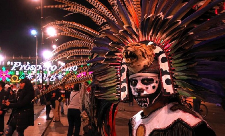 Mexicans dress up in creative costumes for tourists, blending the present with the past as culture meets Christmas in the heart of Mexico City's plaza.