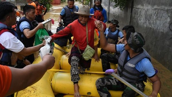 Rescuers evacuate residents during heavy flooding in Cagayan de Oro city in the Philippines, Dec. 22, 2017.