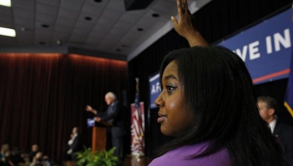 Erica Garner raises her hand to ask U.S. Democratic presidential candidate Bernie Sanders a question in 2016.