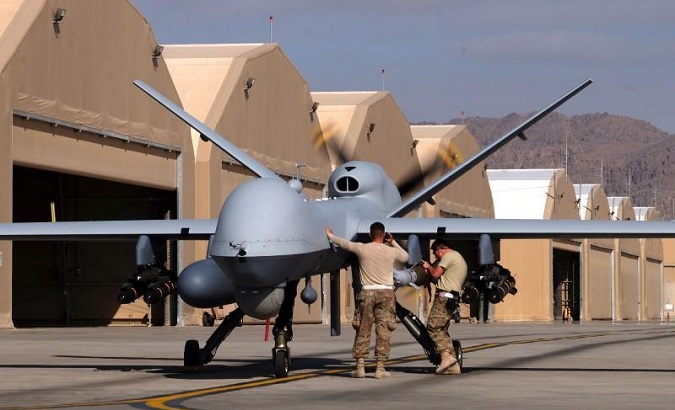 U.S. airmen prepare a U.S. Air Force MQ-9 Reaper drone as it leaves on a mission at Kandahar Air Field, Afghanistan March 9, 2016.