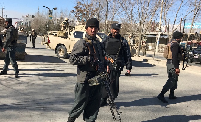 Afghan policemen stand guard at the site of a blast in Kabul, Afghanistan Dec. 28, 2017.