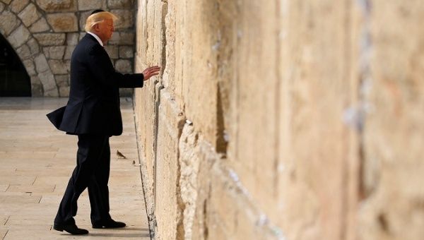 Donald Trump leaves a note at the Western Wall in Jerusalem during a visit to Israel earlier this year.