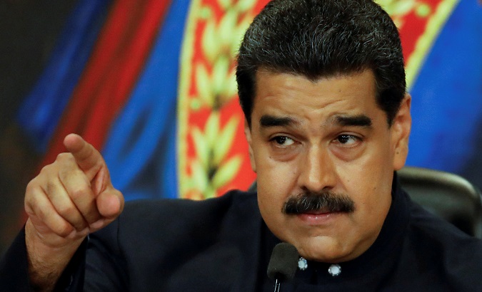 Venezuela's President Nicolas Maduro gestures while he talks to the media during a news conference.