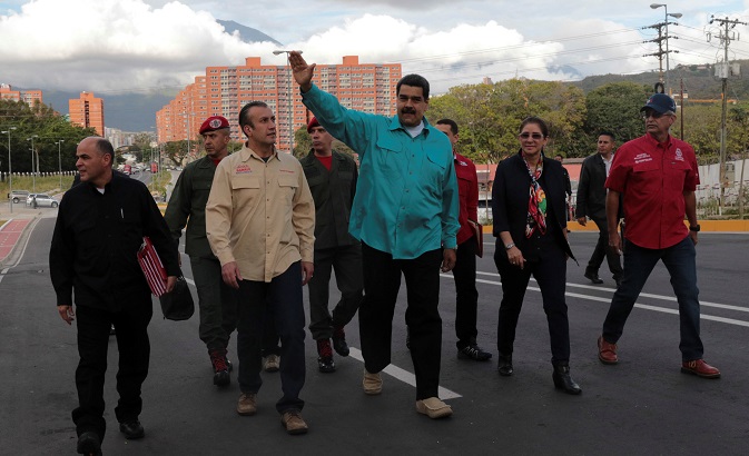 Venezuelan President Nicolas Maduro (C) waves as he arrives for an event to hand over residences built under the government's housing program.