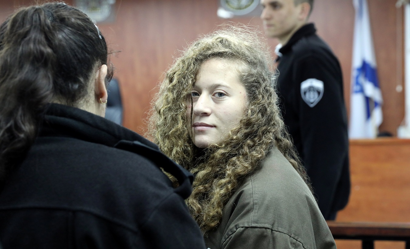 Palestinian teen Ahed Tamimi (R) enters a military courtroom escorted by Israeli Prison Service personnel at Ofer Prison, near the West Bank city of Ramallah, Jan. 1, 2018.