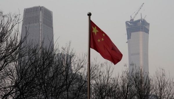 China World Trade Center Tower III (L) and China Zun Tower under construction are pictured behind a Chinese flag in Beijing's central business area, China December 14, 2017. 