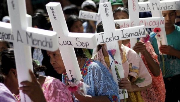Women hold makeshift crosses during a march to commemorate International Day for the Elimination of Violence Against Women, in Guatemala City.