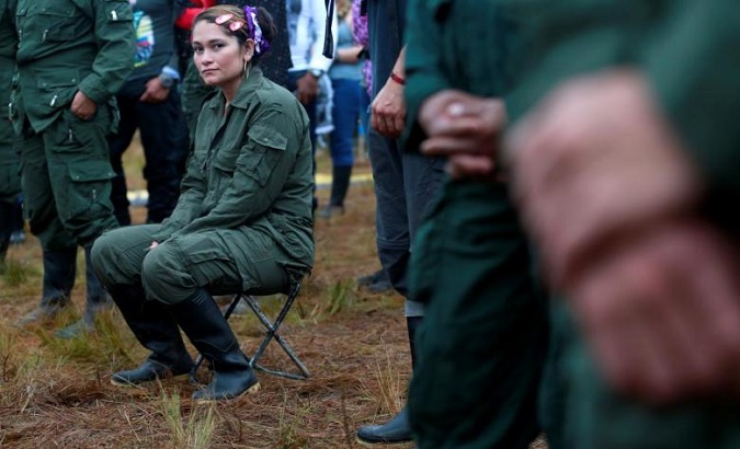 A fighter from FARC seats during the opening of ceremony congress at the camp where they prepare for ratifying a peace deal with the government, near El Diamante in Yari Plains, Colombia. Sept. 16, 2016.