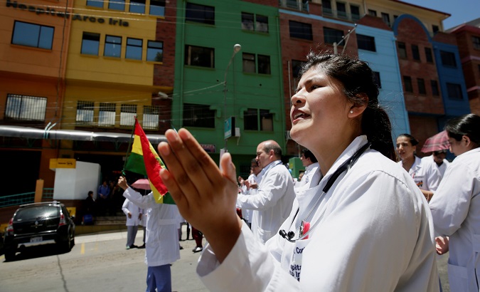 Healthcare employees protest in front Arco Iris Hospital during a strike against Bolivia's government policies for health rules, in La Paz, Bolivia, December 12, 2017.