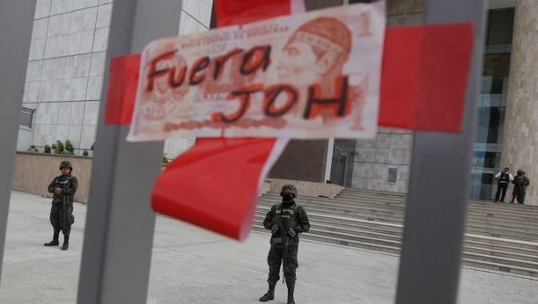 Soldiers guard the entrance of Honduras Central Bank as supporters of opposition candidate Salvador Nasralla march to protest against the results of Honduras' general elections in Tegucigalpa
