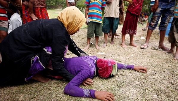 Rohingya refugee woman is consoled after receiving news that her husband was killed in Myanmar.