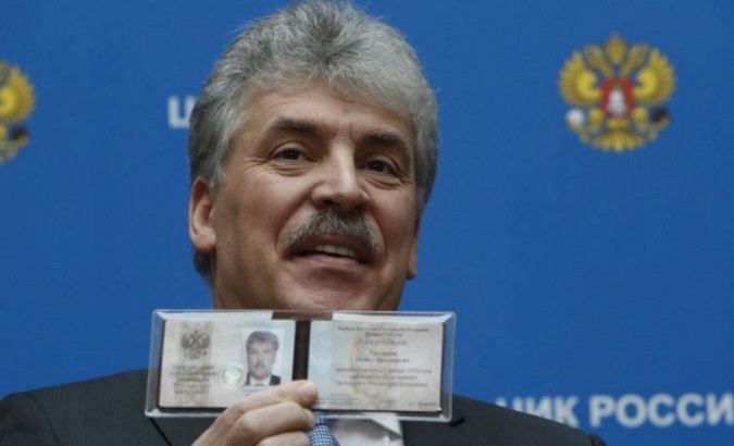 Businessman Pavel Grudinin, representing the Russian Communist Party, demonstrates his identity document after he was registered as a presidential candidate.