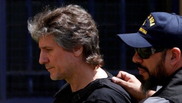 Former Argentine Vice President Amado Boudou is escorted by a member of Argentina's Coastguards as he arrives at a Federal Justice building in Buenos Aires.