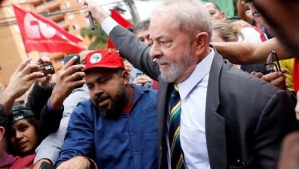 Former Brazilian President Luiz Inacio 'Lula' da Silva walks with supporters.